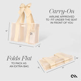CARRY ON AIRLINE APPROVED TO FIT UNDER YOUR SEAT. FOLDS FLAT TO PACK AS AN EXTRA BAG #color_ecru raffia bow